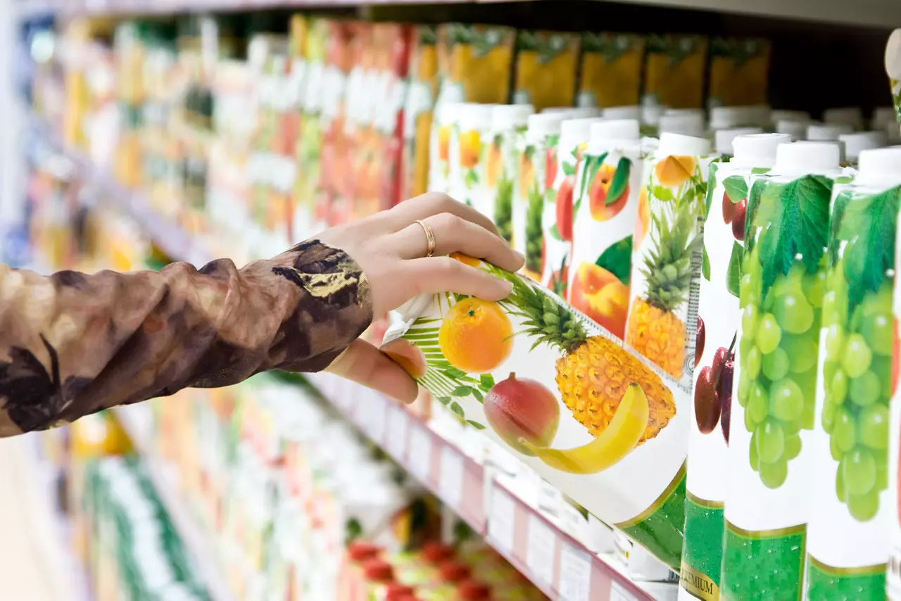 Woman selecting fruit juice