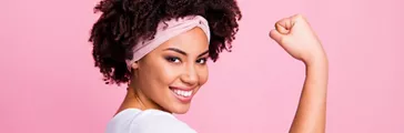 Wavy-haired Woman Showing Muscles Isolated Over Pink Pastel Background