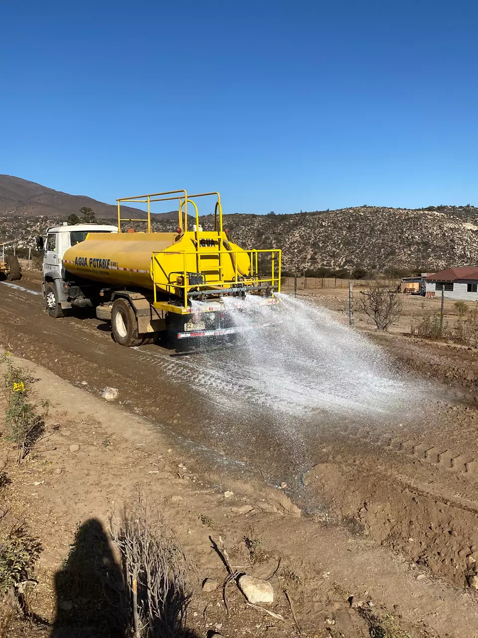 Truck spraying solution on the soil.