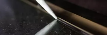 Silicone adhesive application from cartridge tube onto a mirror